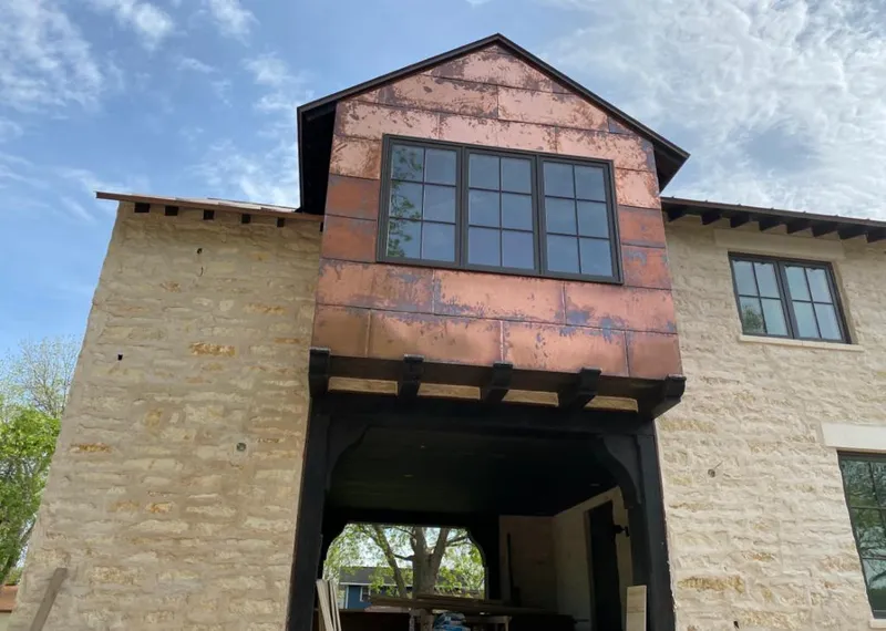 Copper metal panel facade on a stone building for Roof Repair in Wetumpka
