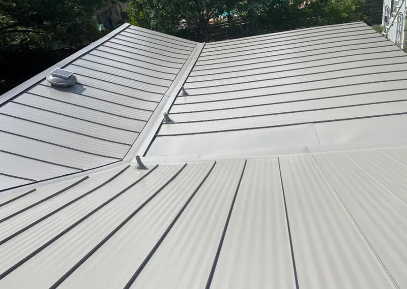 Solar attic fan installed on a metal roof for Roof Ventilation in Wetumpka